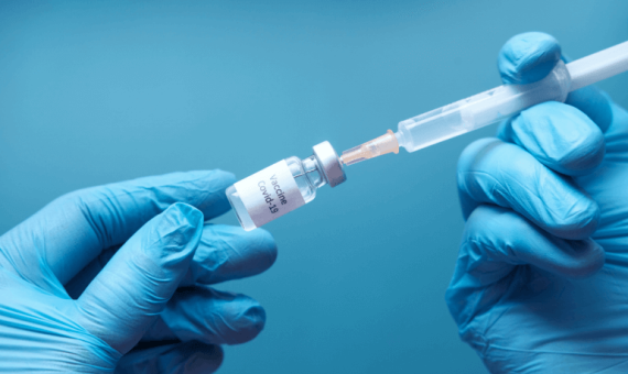 Szczepionka na COVID w dłoniach ze strzykawką